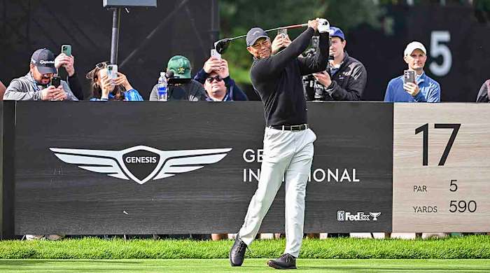 Tiger Woods plays his shot from the 17th tee while members of the media take video and photos behind him during practice for the 2024 Genesis Invitational at Riviera Country Club in Pacific Palisades, Calif.